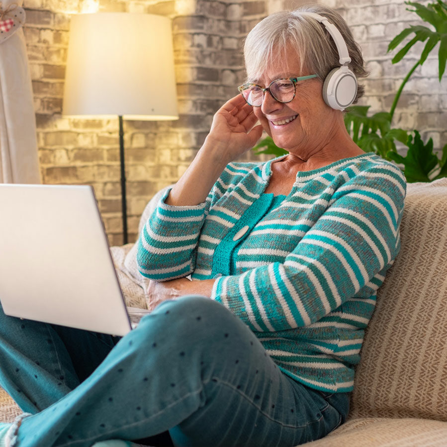 retired woman taking telehealth music therapy lessons online